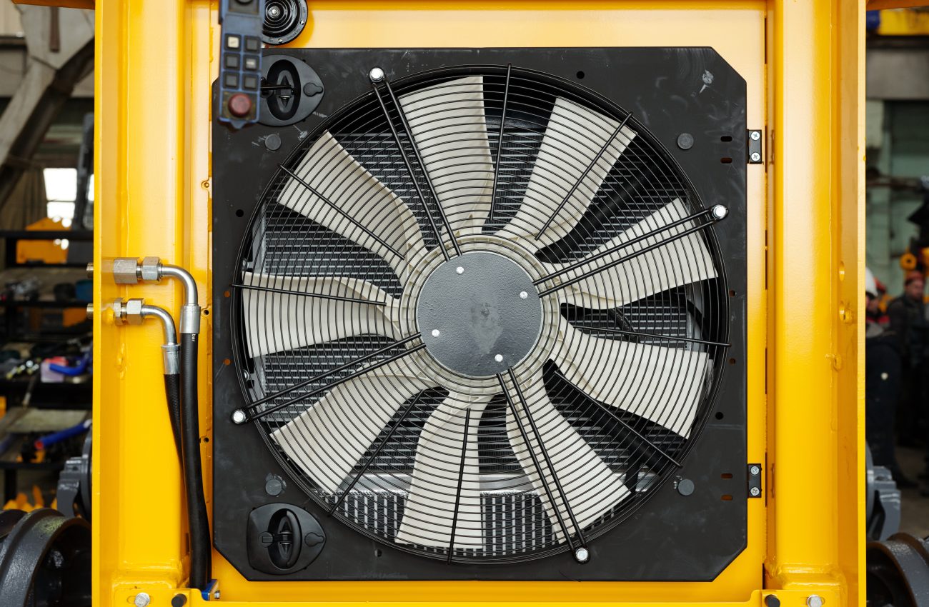 Close-up of part of huge industrial or construction machine with electric fan necessary dor cooling its engine during work